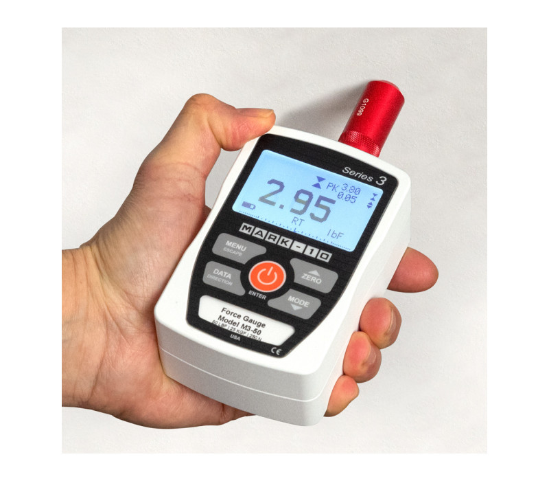 Le G1099 est ici présenté dans une application de mesure de la force de perforation de plaques de plâtre avec un dynamomètre M3-50.